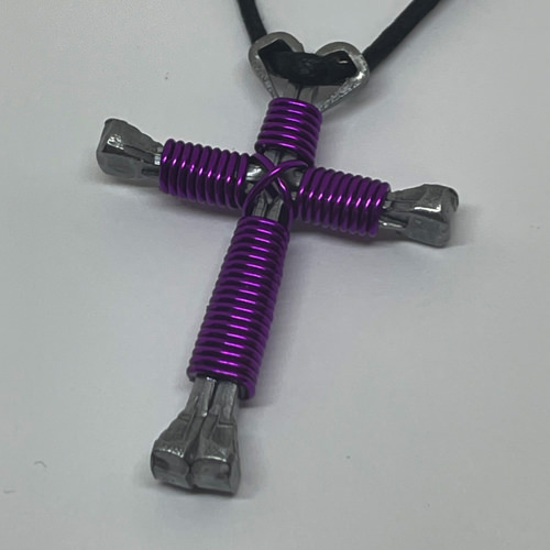 Nail cross necklace wrapped with bold amethyst wire.